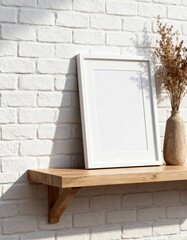 Mockup white picture frame on wooden shelf with dried flowers in vase against white brick wall