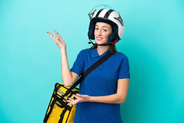 Young caucasian woman with thermal backpack isolated on white background extending hands to the side for inviting to come