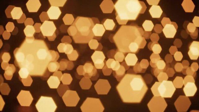A soft-focus abstract composition of glowing golden hexagonal shapes floating against a dark background