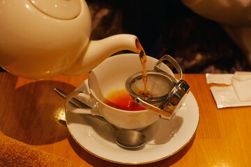pouring tea into tea cup
