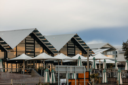 Rows of picnic umbrellas in alfresco dining area of coastal Australian hotel