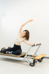 ピラティス女子 日本人女性がリフォーマーでポーズ