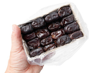 Dried dates in hand isolated on white background. Close-up
