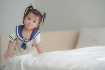 Cute baby lying on bed in soft natural light
