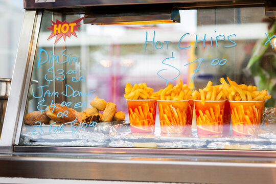 Hot chips in buckets and jam donuts at sideshow food stall at event
