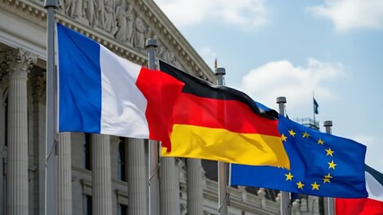 European and national flags waving in harmony against a historic building backdrop
