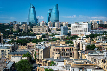 Panoramic view of Baku’s old town architecture with modern towers and city buildings in the background under a clear sky.