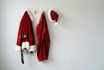 Santa Claus Costume and Hat Hanging on a Wall, Waiting for Santa