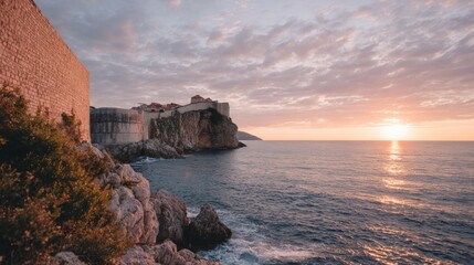 Beautiful landscape photograph of a sunset over the ocean. the sky is filled with orange and pink hues, with the sun partially visible on the right side of the image.