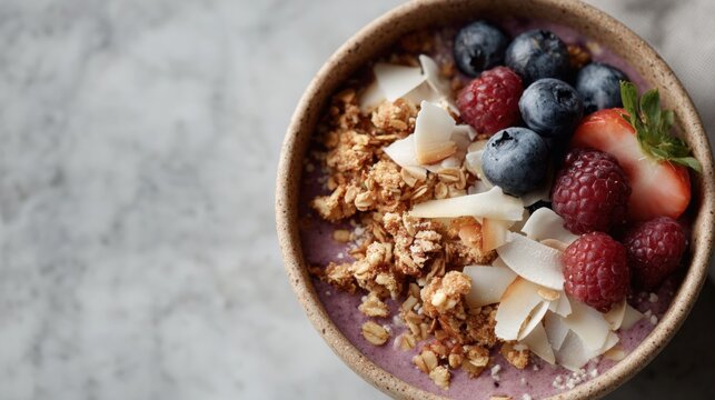 Close-up of a bowl of fruit smoothie. the bowl is made of ceramic and is placed on a white marble countertop. - Powered by Adobe