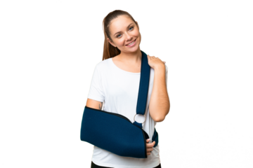 Young blonde woman with broken arm and wearing a sling over isolated chroma key background laughing