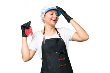 Butcher woman wearing an apron and serving fresh cut meat over isolated chroma key background smiling a lot