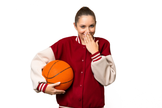 Young blonde woman playing basketball over isolated chroma key background happy and smiling covering mouth with hand