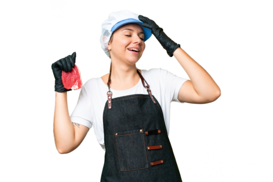 Butcher woman wearing an apron and serving fresh cut meat over isolated chroma key background smiling a lot