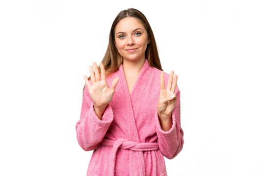Young woman in a bathrobe over isolated chroma key background counting eight with fingers