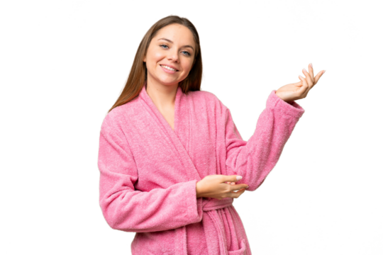 Young woman in a bathrobe over isolated chroma key background extending hands to the side for inviting to come