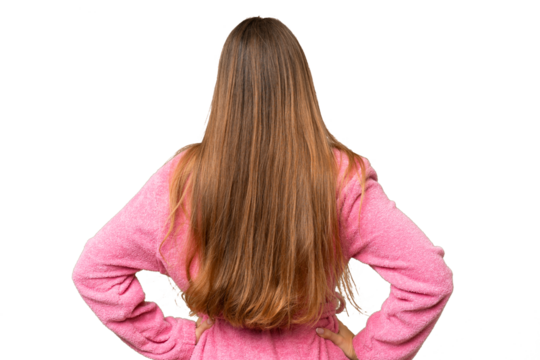 Young woman in a bathrobe over isolated chroma key background in back position