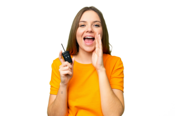 Young woman holding car keys over isolated chroma key background shouting with mouth wide open
