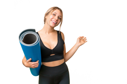 Blonde sport woman going to yoga classes while holding a mat over isolated chroma key background extending hands to the side for inviting to come
