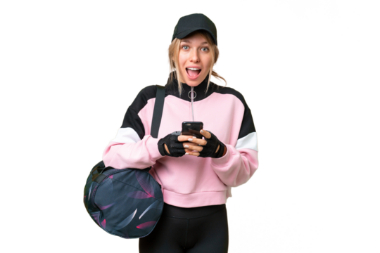 Pretty sport woman with sport bag over isolated chroma key background surprised and sending a message - Powered by Adobe