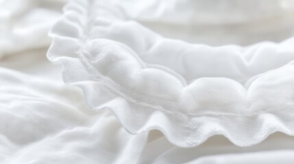A close up view of a collection of sterile absorbent pads with soft white fabric and ruffled edges