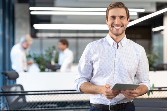 Handsome businessman using his tablet in the office