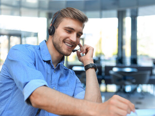 Smiling friendly handsome young male call centre operator