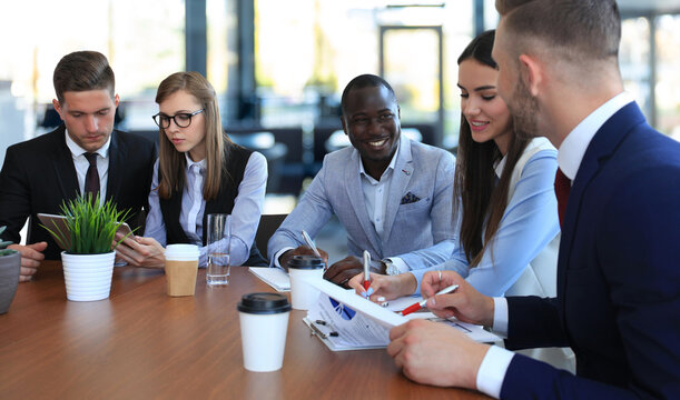 group of business people at a meeting on the background of office