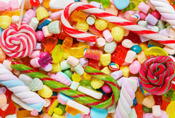 colorful candies, jellies, marshmallows, lollipops and marmalade as background, top view