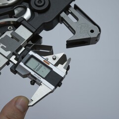 Fototapeta premium a person holding a small electronic device with a digital display