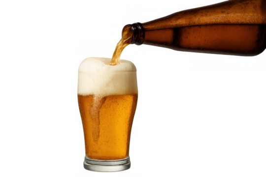 Pouring golden beer from bottle into a pint glass, creating a perfect foamy head. Refreshing alcoholic drink