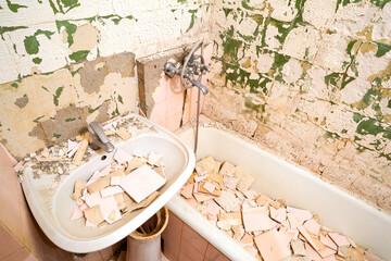 Bathroom renovation. Old broken ceramic tiles in the bathroom.