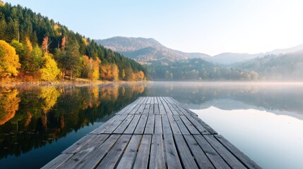 Wooden pier extending into a calm lake with autumn forest and mountains in the background, reflected on the still water. Peaceful nature scene for tranquil concept.