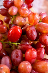 Red Grape Close-up: a collection of vibrant red grapes, glistening with a fresh, juicy appeal, inviting a sensory delight.