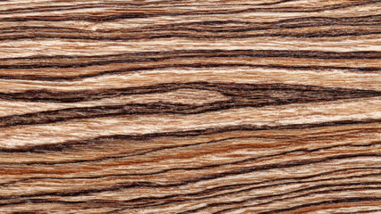Fototapeta premium Striking close-up of natural wood grain texture. Features distinct horizontal stripes of light beige and dark brown, resembling exotic timber surface.