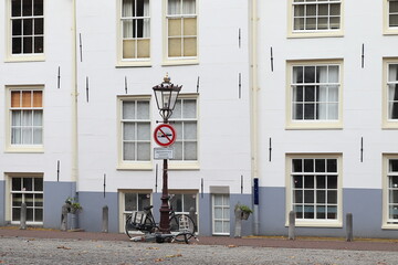 Amsterdam Street View with Vintage Lamp Post and No Public Drinking Warning Sign, Netherlands