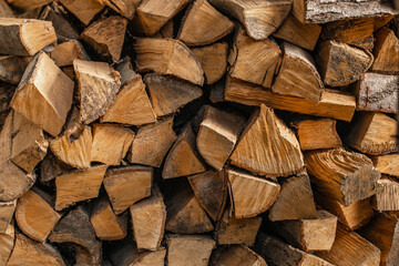 Stack of chopped firewood logs with natural rustic texture, close-up background for forestry, heating, eco fuel and countryside themes