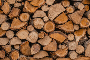Stack of natural firewood logs in rustic pile