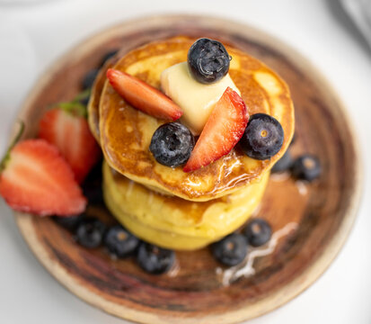 Top View Stack of Pancakes on Plate with Berries - Powered by Adobe