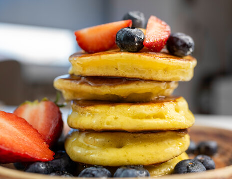 Close-Up Stack of Pancakes with Strawberries and Blueberries on Plate