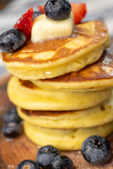 Close-Up Stack of Pancakes with Butter and Berries