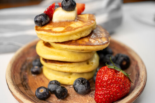 Stack of Pancakes on Plate with Butter and Berries
