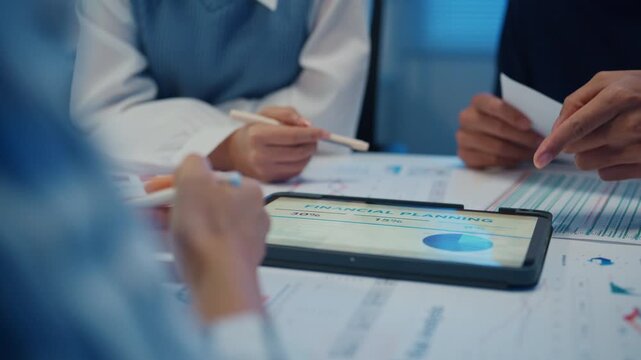 Close up asia businesspeople meeting plan analysis statistics brainstorm and tablet point graph chart employee take note in office conference room at night. Business finance partners strategy success.