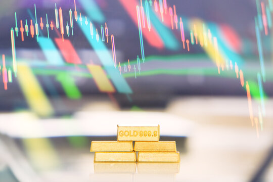 Gold Bars and Market Chart Investment Concept