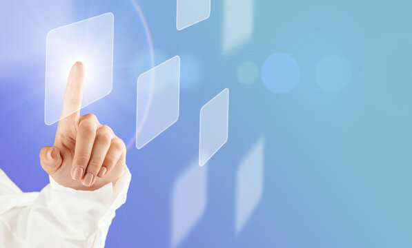 Hand touching virtual interface button on a futuristic digital screen