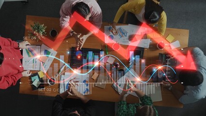 A diverse group of professionals collaborates in an office setting, analyzing data trends and discussing business strategies over charts and graphs, fostering teamwork. Raster