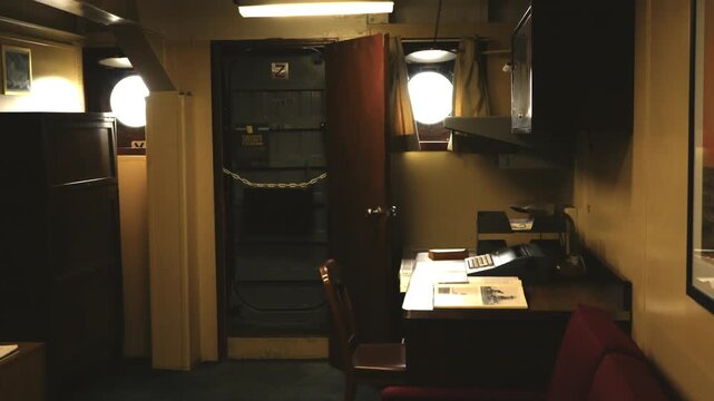 Smooth camera move transitioning from the exterior roof section into an officers&rsquo; stateroom aboard a United States Navy battleship.