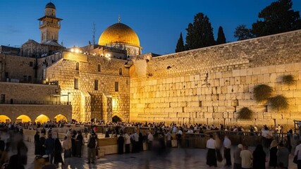 A serene gathering at Jerusalem's Western Wall under the night sky.