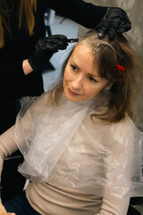 Woman with brown hair changing hair style. Beauty transformation. Hair dye concept. Natural women beauty. Hair colouring in beauty salon. Bride preparing for wedding. Hairstyle concept. 