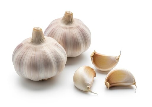 Two whole garlic bulbs and three cloves isolated on white background